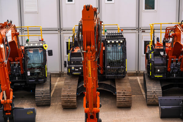 AI-equipped Hitachi excavators lined up before deployment on UK projects.